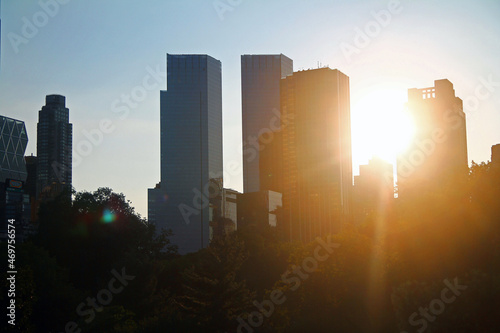 The sunset behind the modern skyscrapers from Central Park