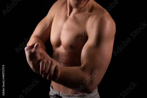 Man Showing Biceps Hands Up. Sportsman Showing Muscles. ABS, Biceps Muscles. Black Background. Topless Man Hand Close Up