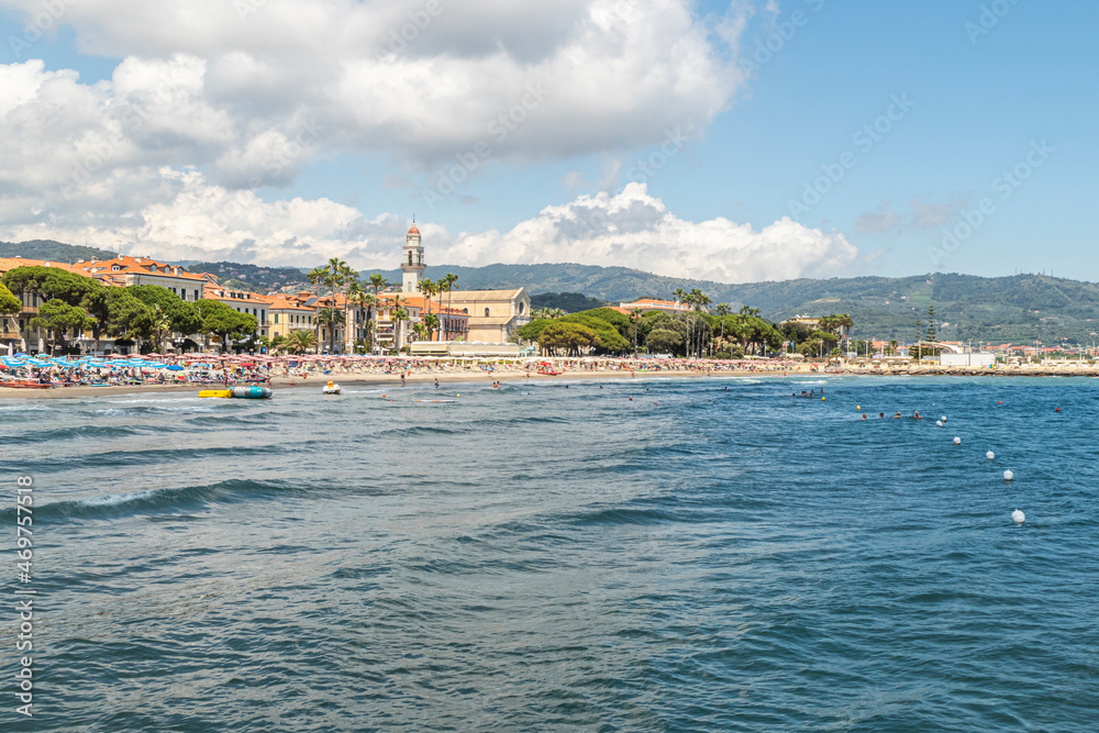 The beach of Diano Marina with a beautiful church in background