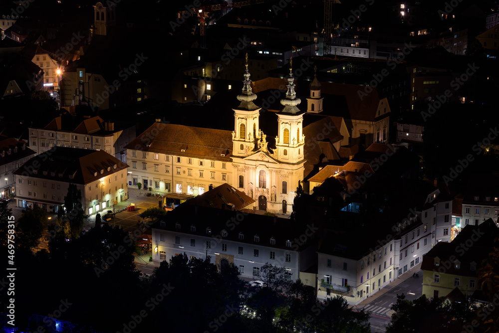 Night view of the Mariahilf Church (Mariahilfkirche) and the Minorite monastery (Minoritenkloster), seen from Schlossberg Park hill, Graz, Austria