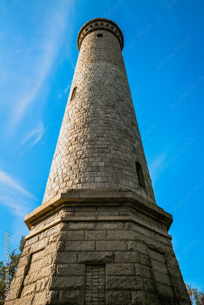Myles Standish Monument on blue sky background, low angle view close-up.