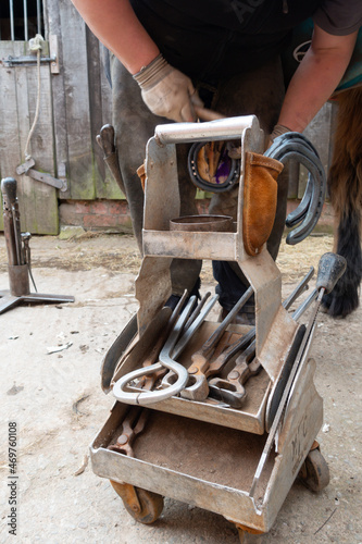 Tools of the trade, Farrier keeps his tool box close at hand as he shoes a horse, a skilled tradesman and a difficult job. photo