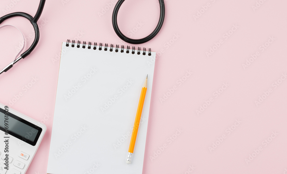 Calculator with a stethoscope on a pink table. Calculator with a stethoscope on a pink table.