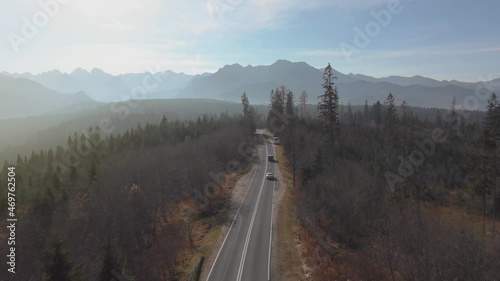 Alpine road with curves in the direction of the Polish and Slovak Tatra Mountains. Driving on dangerous winding mountain road in the fog at dawn in the nature. Luxury car.