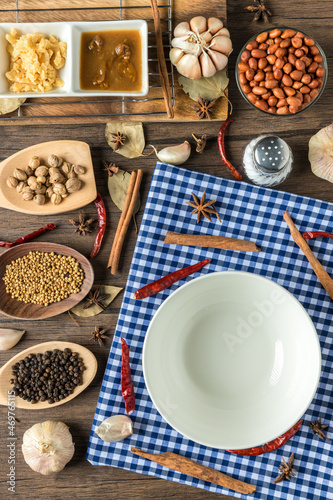 White Circle Dish and Ingredients and spices on background. Healthy cooking concept. empty circle white dish on wooden background.	