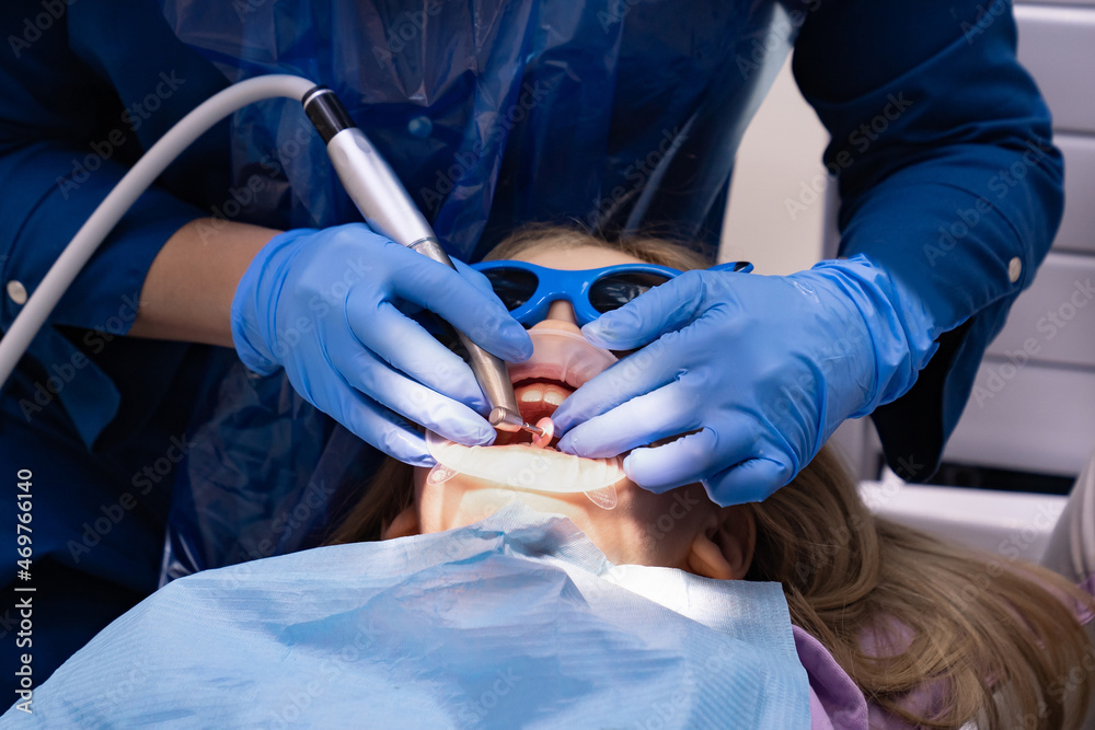 kid with oral dilator at dentist's appointment. treatment of teeth