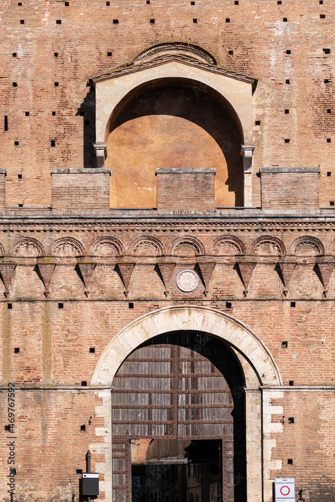 Porta Ovile, Imposing city gate from the 13th century with a curved arch and battlements, Siena, Tuscany, Italy