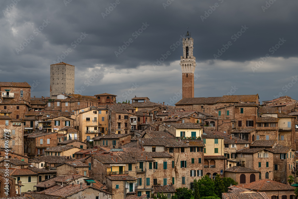 Panoramic View over Siena with Torre del Mangia in Evening light with dramatic Sky, Siena, italy