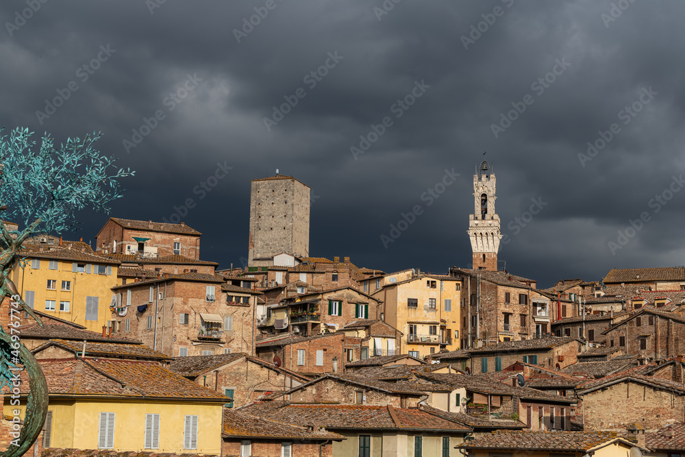 Panoramic View over Siena with Torre del Mangia in Evening light with dramatic Sky, Siena, italy