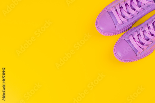 Ultra Violet sneakers on yellow background. Concept of healthy lifestile and food, everyday training and force of will.