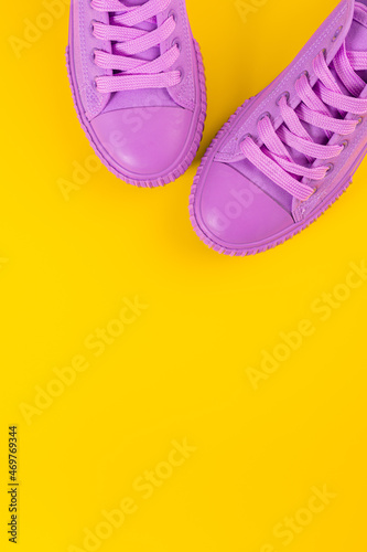 Ultra Violet sneakers on yellow background. Concept of healthy lifestile and food, everyday training and force of will.