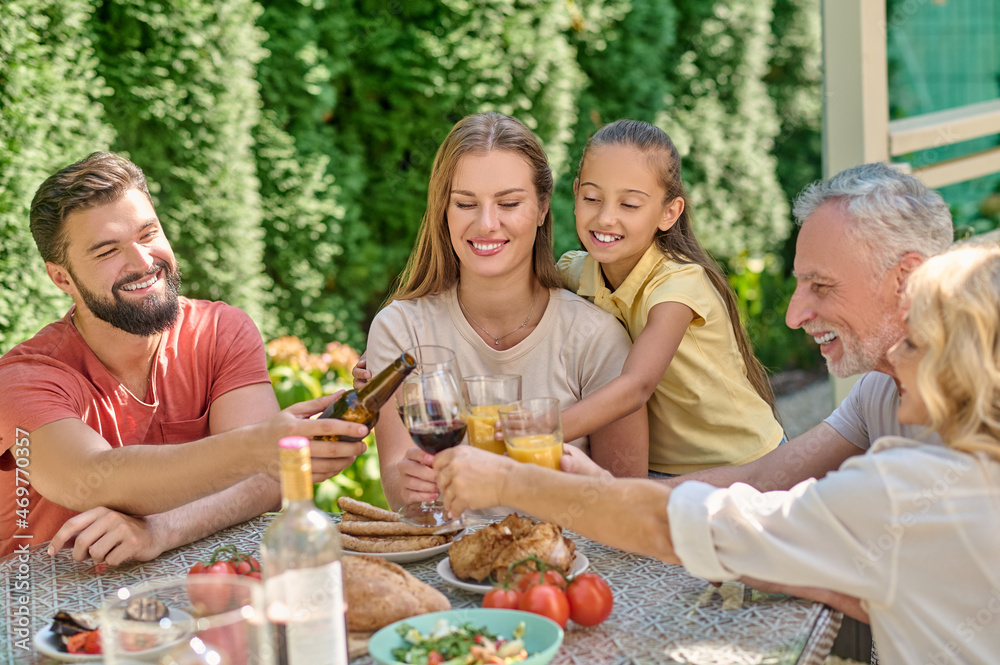 A family sitting at the dinner table and looking joyful A family sitting at the dinner table and looking joyful