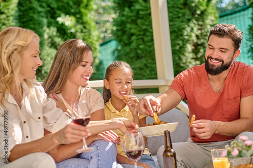 A smiling family sitting at the dinner table