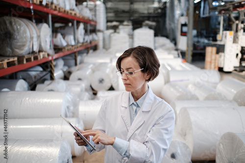Female worker using tablet at the factory
