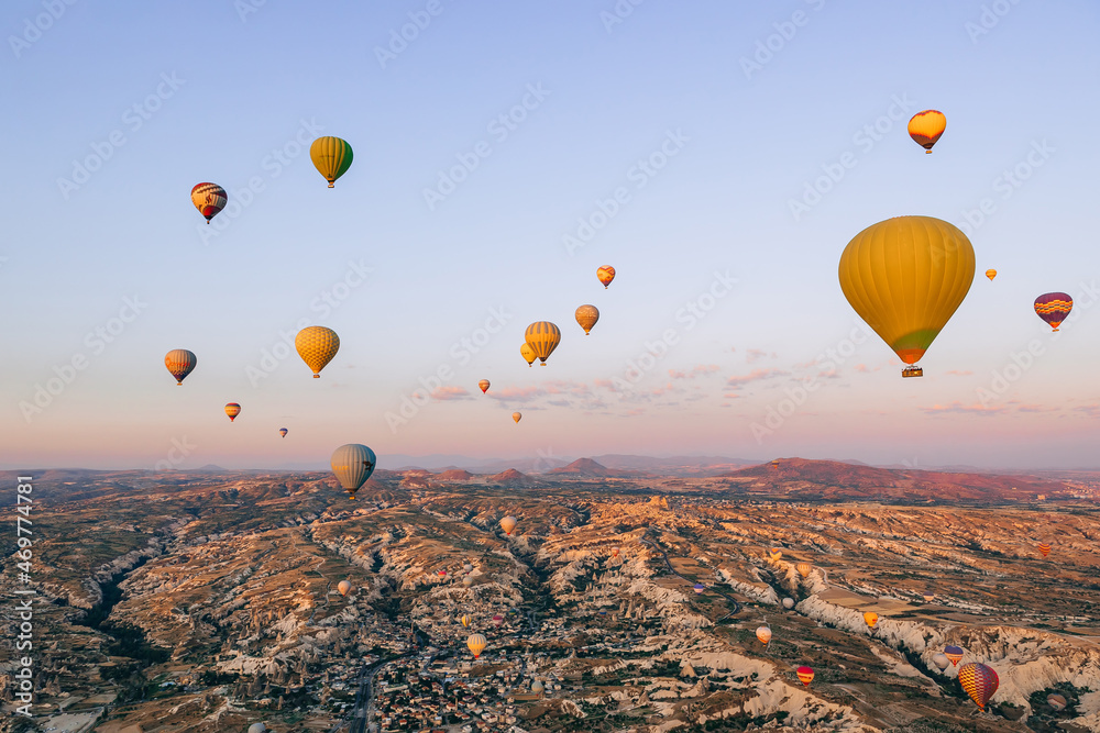 Beautiful bright colorful balloons in the light of the sunrise in Cappadocia