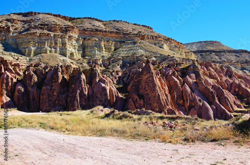 Scenic nature landscape of ancient cavetown near Goreme in Cappadocia. Popular travel destination in Turkey. UNESCO World Heritage Site. Sunny autumn day photo