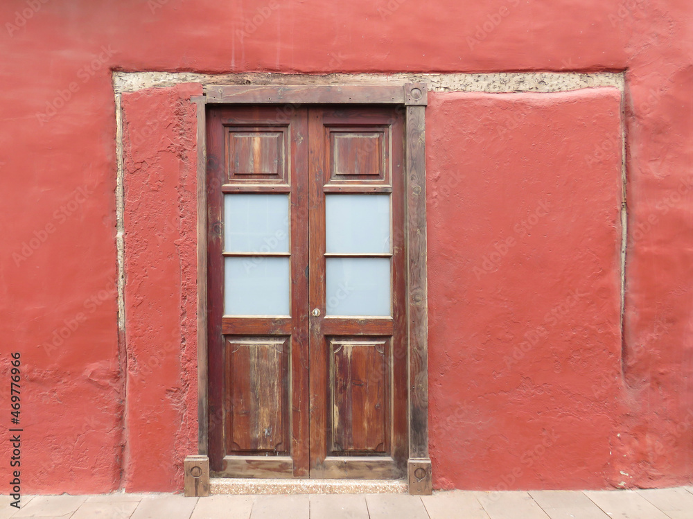 Traditional colonial house with red facade and wooden door. Historic town of Garachico. Tenerife Island. Canary Islands. Spain.