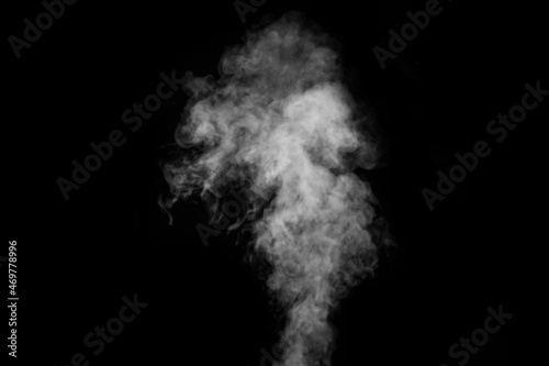 Fragment of white hot curly steam smoke isolated on a black background, close-up.Abstract background, design element