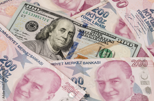 Fototapeta Naklejka Na Ścianę i Meble -  US dollars and Turkish Liras on top of each other completely covering the screen. 1 US dollar being equal to 10 Turkish Liras concept photo shoot