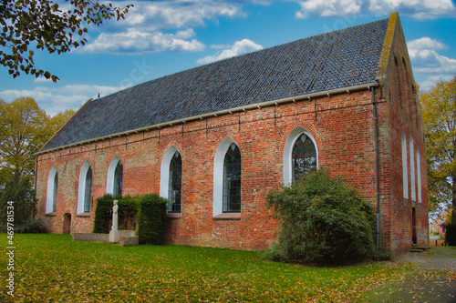 Early-medieval single-nave church.
The 12-th century church of the village of Baflo, province of Groningen, the Netherlands, on an autumn day, with fallen leaves in the foreground.