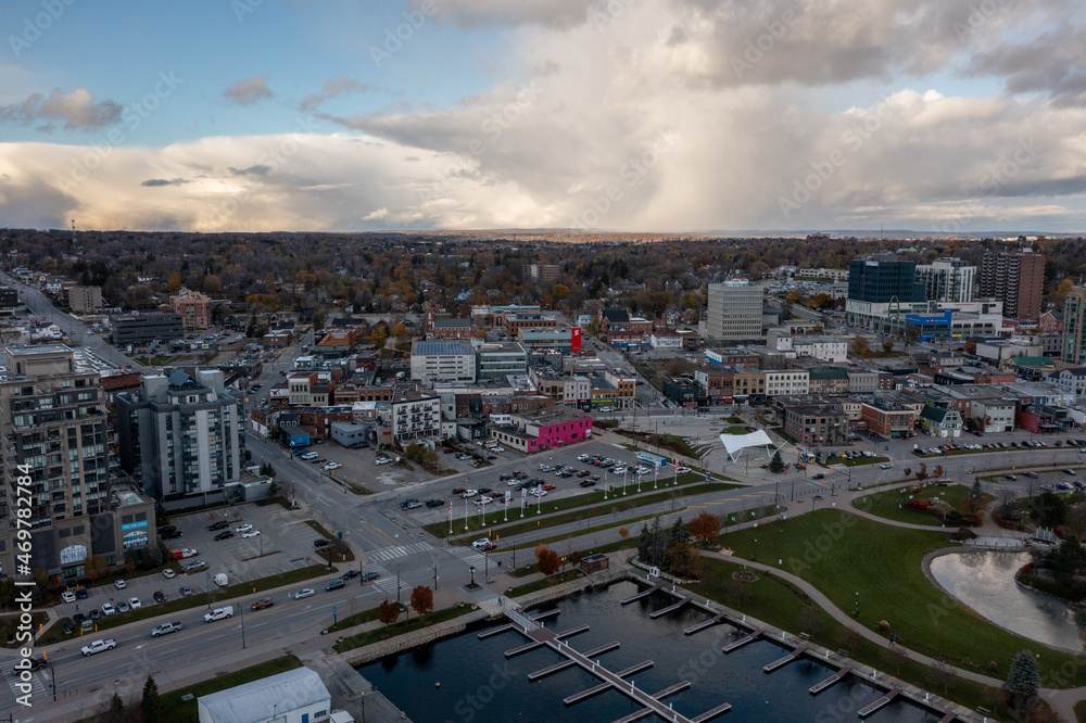 sunset fall Drone view of Barrie waterfront downtown with blue skies and clouds  centennial park and lakeshore drive  road with fall colours  