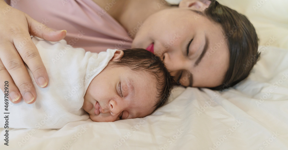 Close up portrait of beautiful young asian mother with her newborn baby, copy space with bed in the hospital background. Healthcare and medical love, lifestyle Indian Arab mother's day concept Close up portrait of beautiful young asian mother with her newborn baby, copy space with bed in the hospital background. Healthcare and medical love, lifestyle Indian Arab mother's day concept