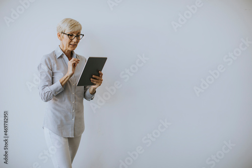 Mature woman using digital ...