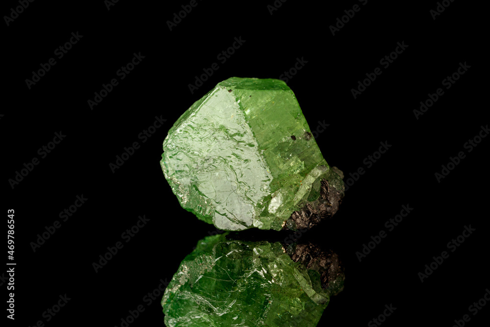 macro mineral stone Demantoid on a black background