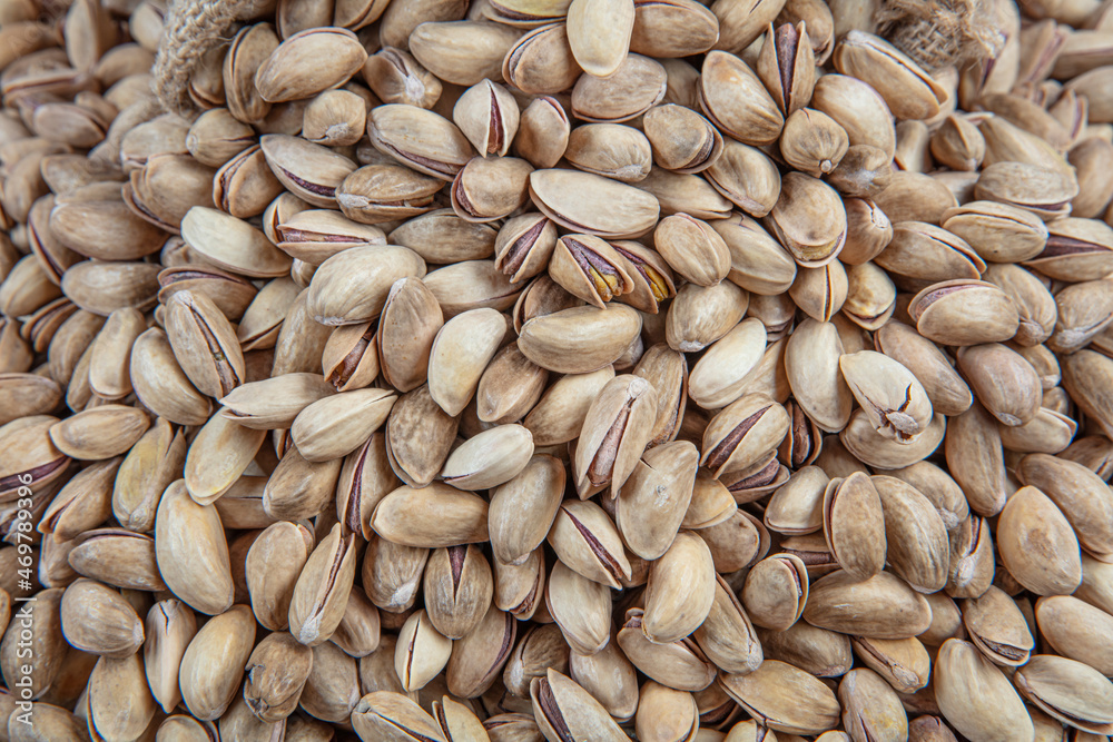 Pistachio nuts. Roasted and salted peanuts in the shell (texture, background). Tasty pistachios as background,as pistachios texture. flat lay Pistachio nuts. Roasted and salted peanuts in the shell (texture, background). Tasty pistachios as background,as pistachios texture. flat lay