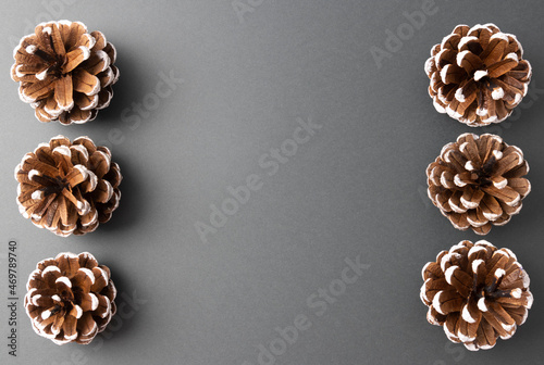 Decorative pine cones on a dark gray background, the basis for a greeting card for Christmas and new Year 2022