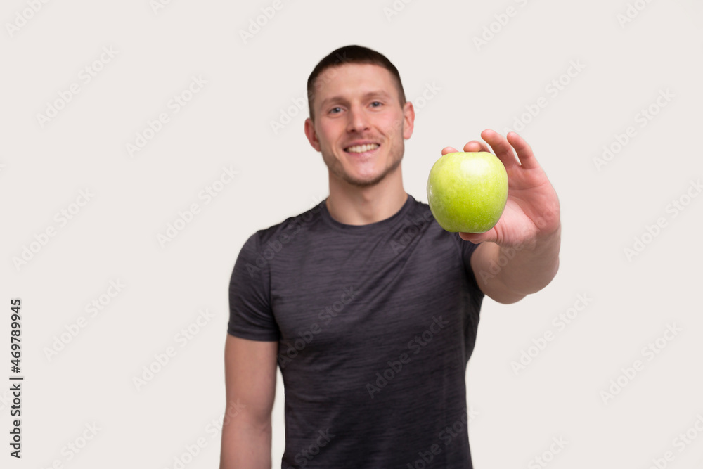 Man Showing Apple. Sportsman with Healthy food in Hands. Muscles, Abs, Biceps, Core. Healthy food, Healthy Eating, Sport, Body, Workout concept Man Showing Apple. Sportsman with Healthy food in Hands. Muscles, Abs, Biceps, Core. Healthy food, Healthy Eating, Sport, Body, Workout concept