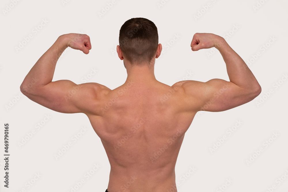 Man Showing Biceps Hands Up. Sportsman Showing Muscles. ABS, Biceps Muscles. Back View Man Showing Biceps Hands Up. Sportsman Showing Muscles. ABS, Biceps Muscles. Back View