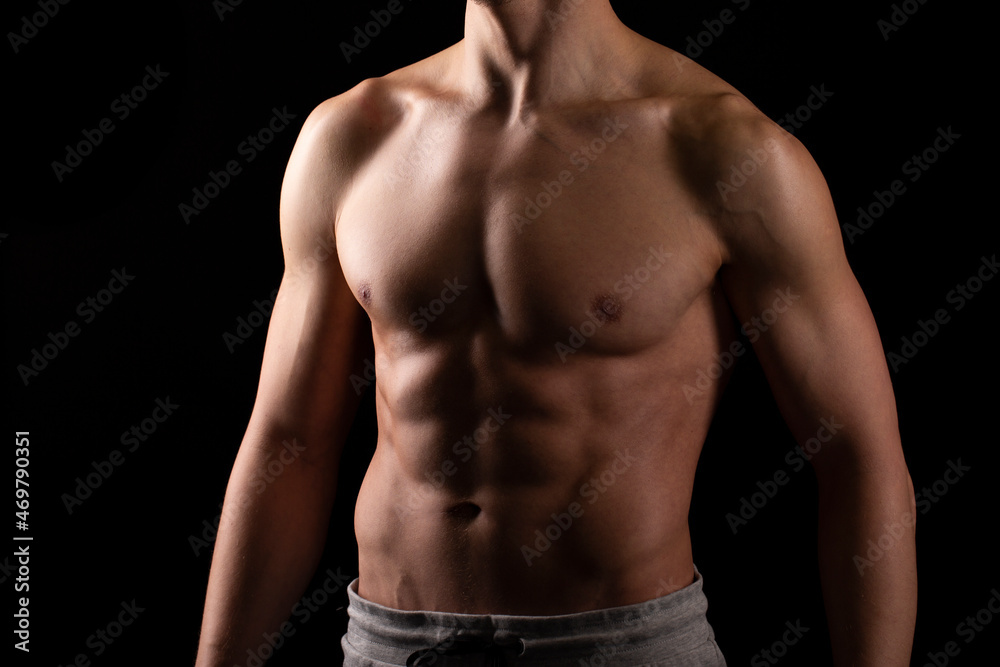 Man Showing ABS. Muscle man Posing. Strong Body Concept. Topless Sportman Bodybuilder. Six Pack