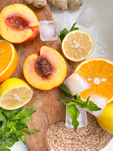 Ginger, peach, lemon, orange, mint, ice cubes - ingredients for juice