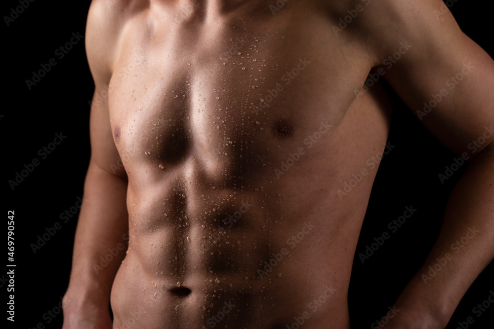 Man Showing ABS. Muscle man Posing. Strong Body Concept. Topless Sportman Bodybuilder. Six Pack