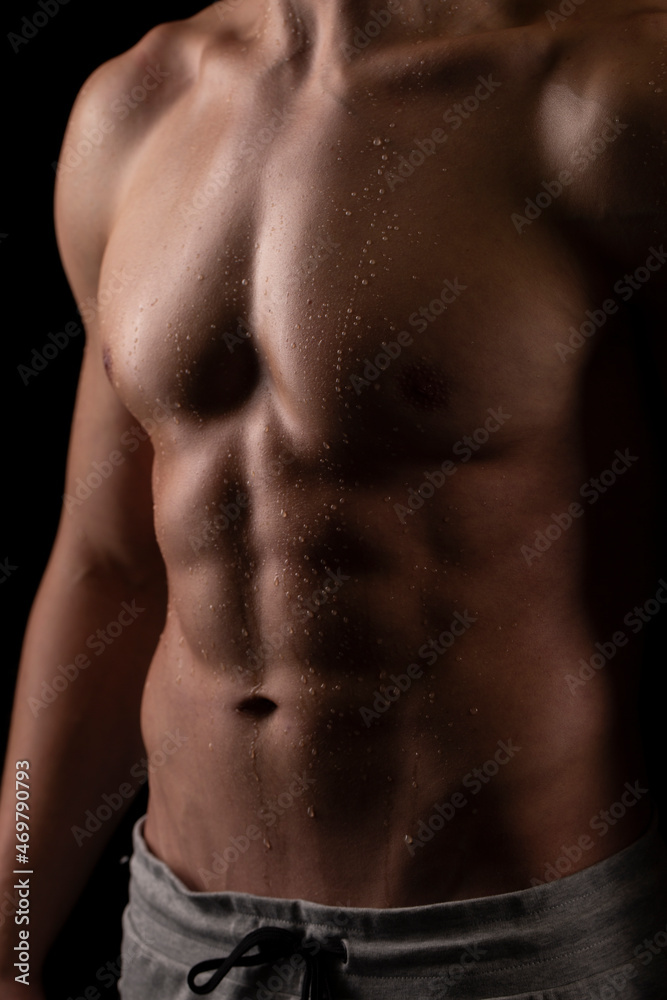 Fototapeta premium Man Showing ABS. Muscle man Posing. Strong Body Concept. Topless Sportman Bodybuilder. Six Pack