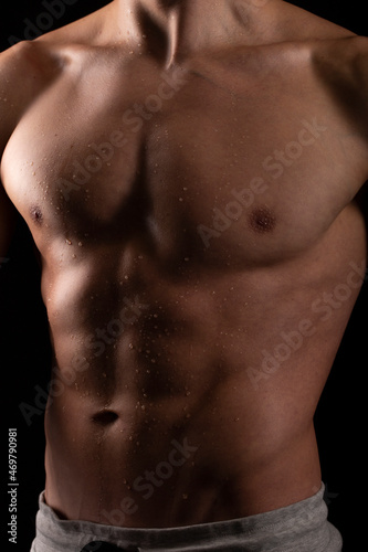 Man Showing ABS. Muscle man Posing. Strong Body Concept. Topless Sportman Bodybuilder. Six Pack