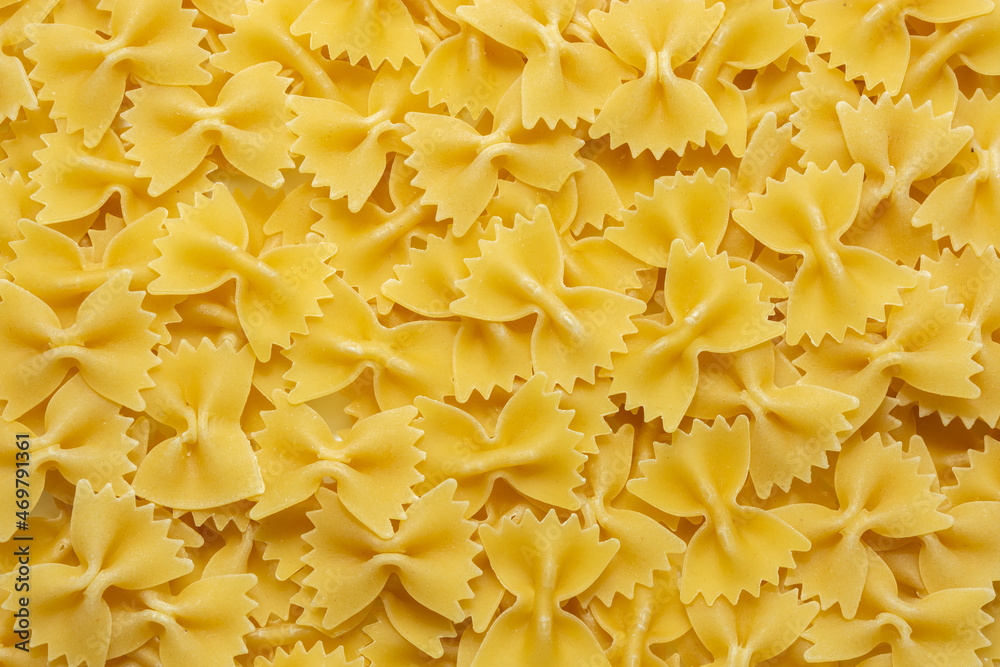 Farfalle. Appetizing raw pasta in the form of bows, butterflies. Grocery culinary background. Farfalle. Appetizing raw pasta in the form of bows, butterflies. Grocery culinary background.