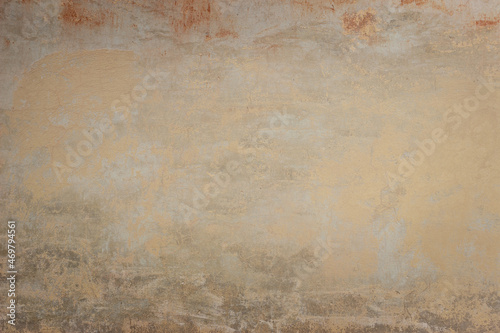 Old ochre concrete wall with different spots and divorces 