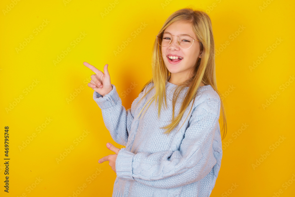 caucasian kid girl wearing blue knitted sweater over yellow background point at copyspace recommend sales discounts caucasian kid girl wearing blue knitted sweater over yellow background point at copyspace recommend sales discounts