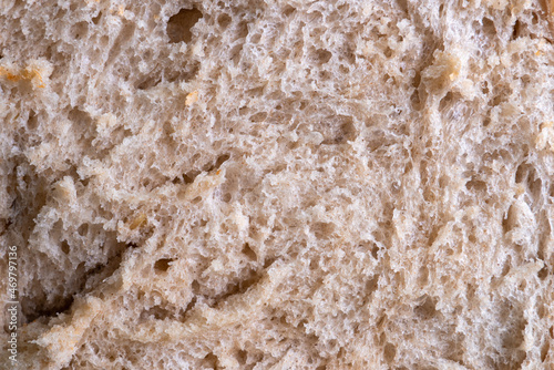 The texture of hot bread from a homemade bread machine. A slice of fresh bread from a bread machine