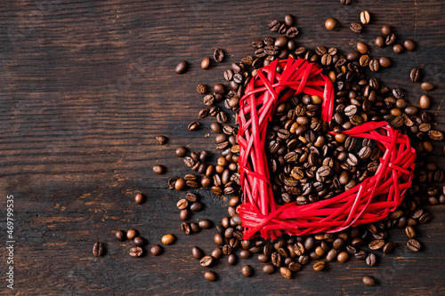 on the old blackboard is a red heart on which the coffee beans. Concept - benefits from drinking coffee. Top view