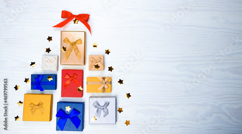Christmas tree made of colorful presents and gifts. Flat lay. Holiday concept.