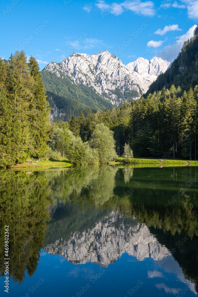 Scenic mountain reflection in the lake Plansansko jezero at Jezersko, Slovenia