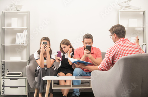 kid with phone addicted daddy and mom sitting at psychologist solving problem, dependency