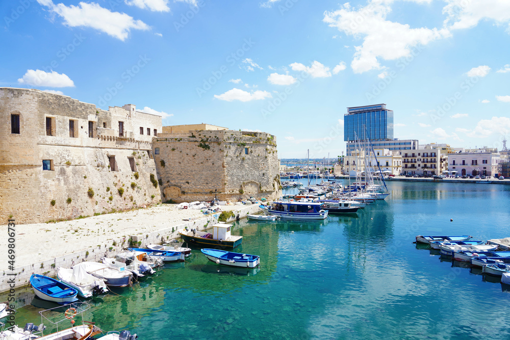 Old port of Gallipoli, view with castle and boats, Apulia, Italy