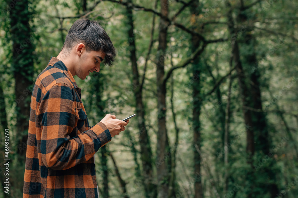 young teenager with mobile phone texting or typing