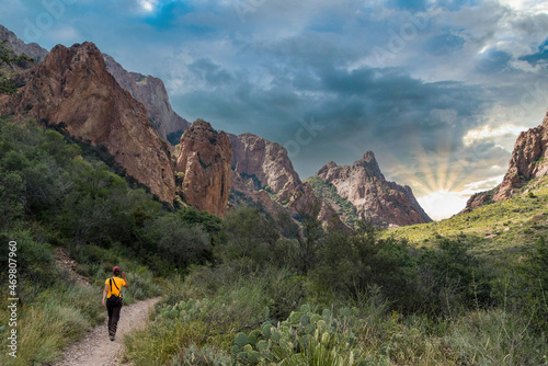 A hiker walking thtough the mountains of Big Bend National Park photo