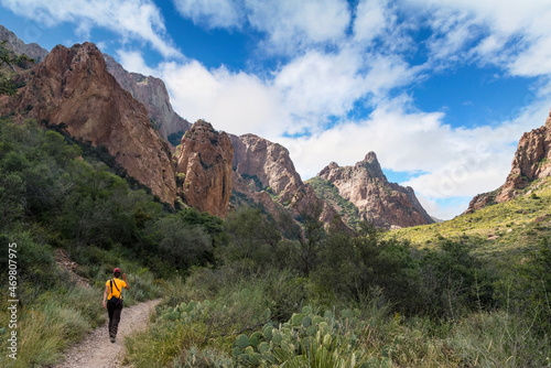 A hiker walking thtough the mountains of Big Bend National Park photo