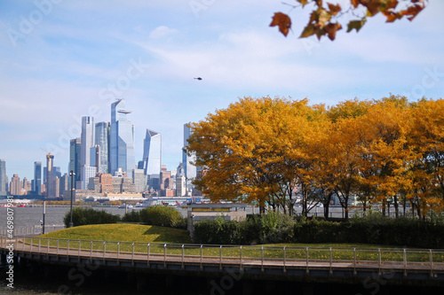 Hudson Yards from Hoboken in a fall day with foliage on the trees